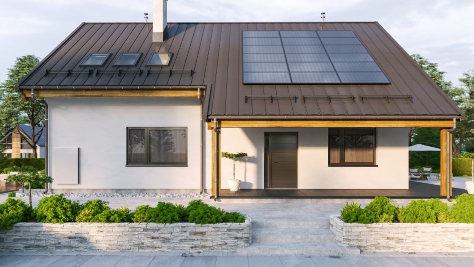 A single-family home with solar panels on the roof and a solar storage battery unit on the exterior wall